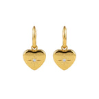 Gold heart-shaped pendant earrings with a starburst design and a small clear stone.