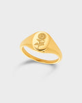 A polished yellow gold signet ring featuring an engraved rose motif on its oval face.