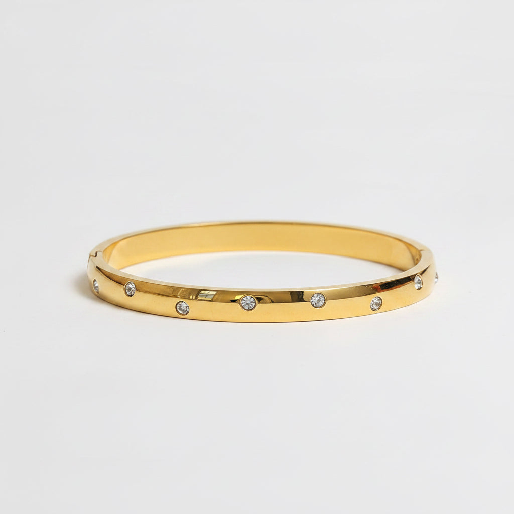 One slim gold bangle bracelets with small clear rhinestones