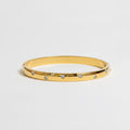 One slim gold bangle bracelets with small clear rhinestones
