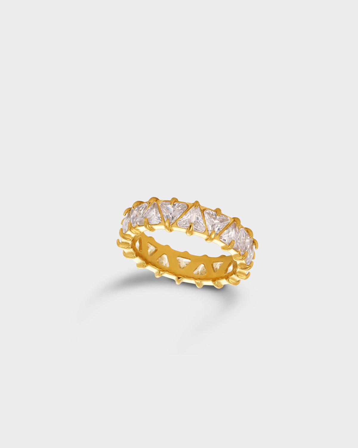 A gold eternity ring featuring a row of clear baguette-cut gemstones in a prong setting.