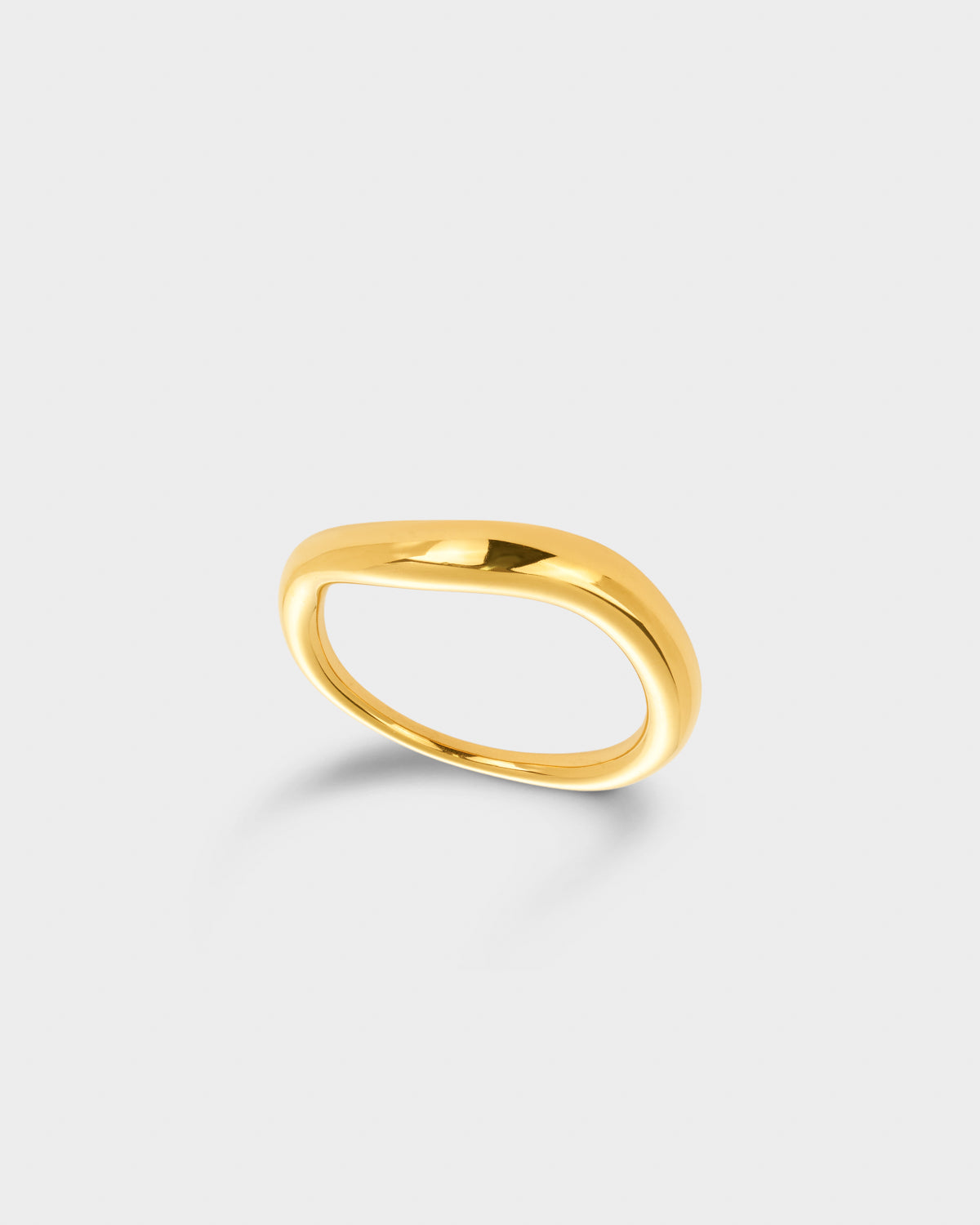 A polished gold band ring with a smooth, rounded organic shape