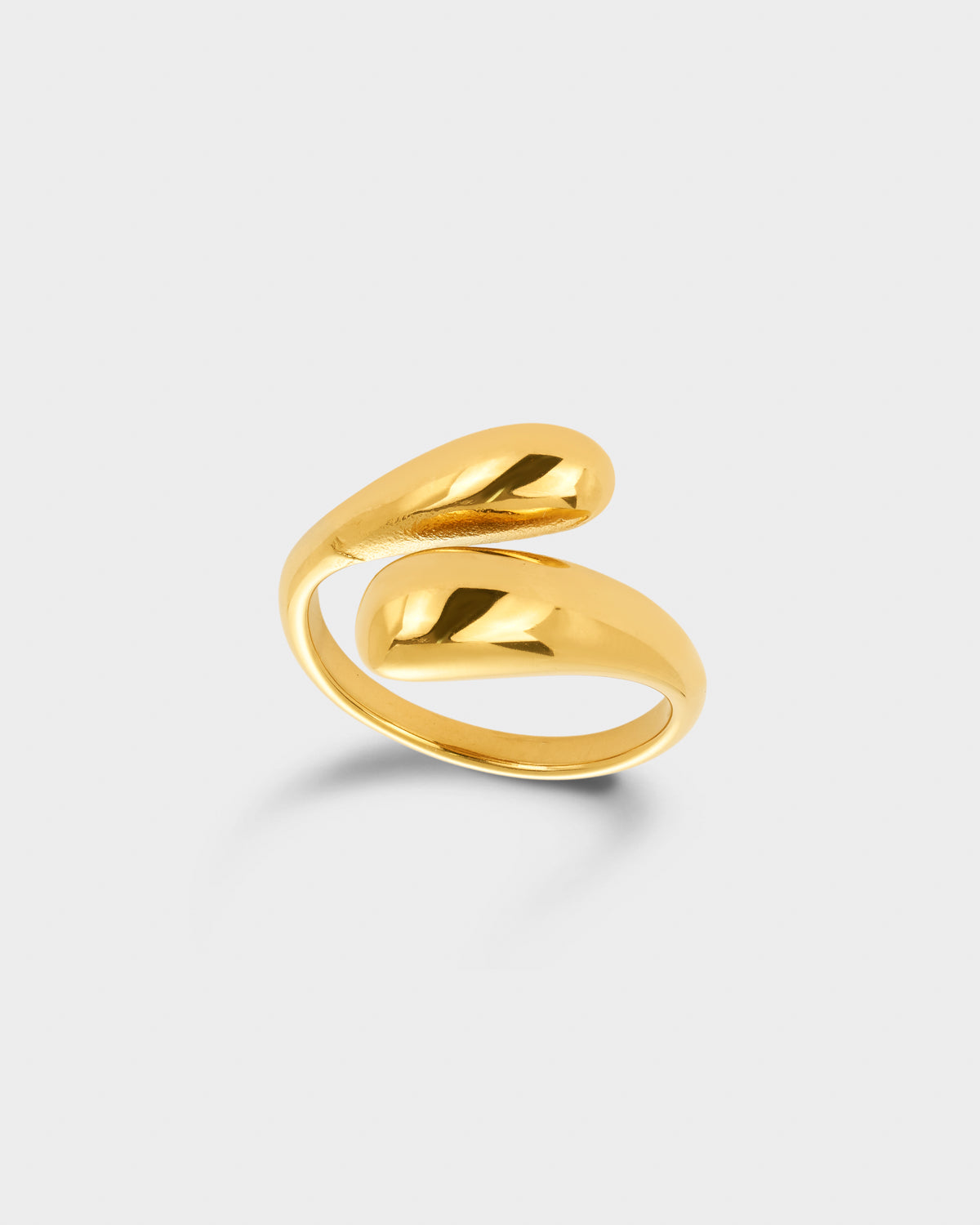 A polished gold wrap ring with a modern, fluid organic shape.