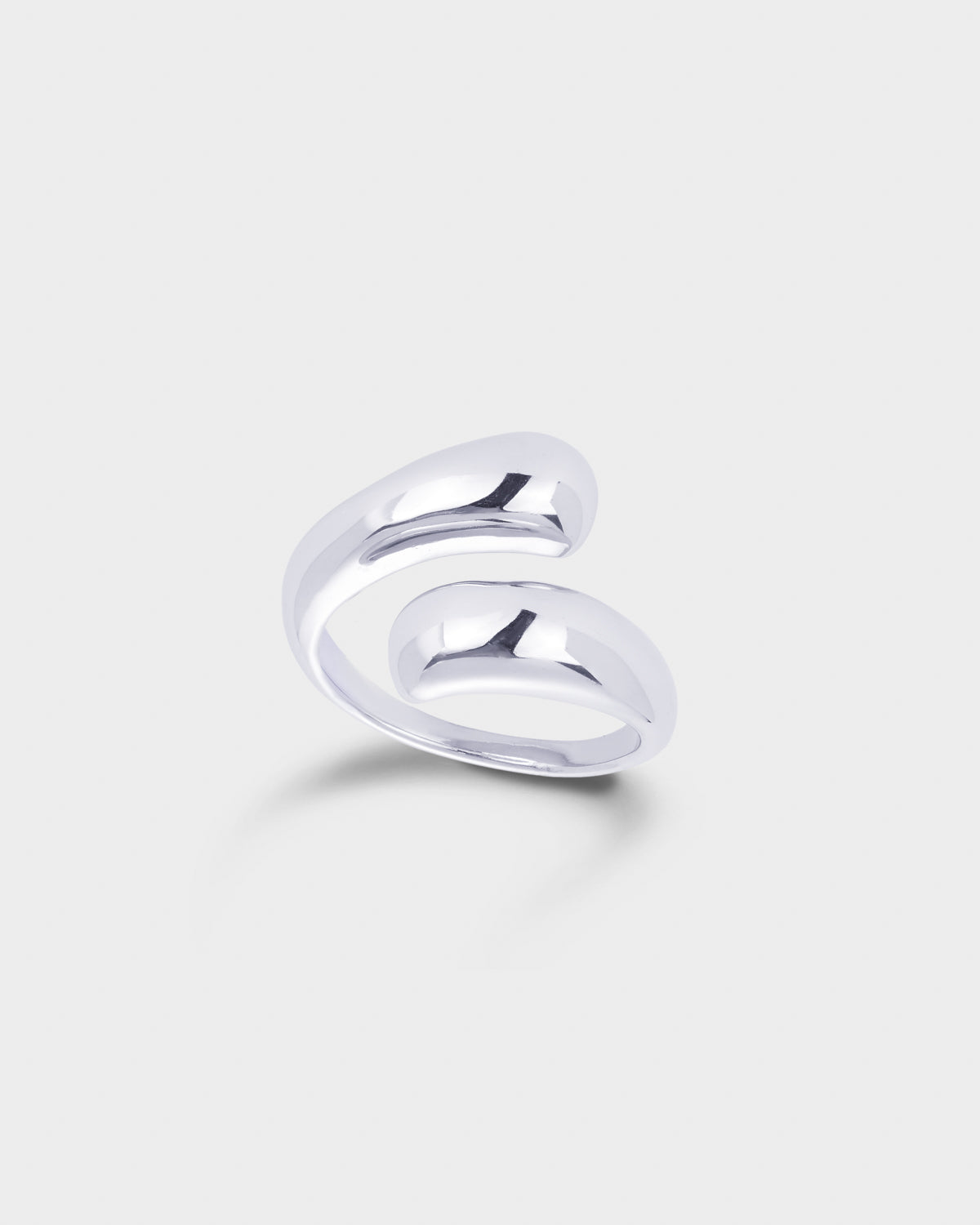A polished silver-toned wrap ring with a smooth, curved design.