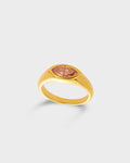 A gold signet ring featuring a marquise-cut peach-colored gemstone.